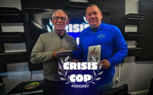 Two men showcasing books, standing in front of a video monitor that says "Crisis Cop" on it in a modern day podcast studio
